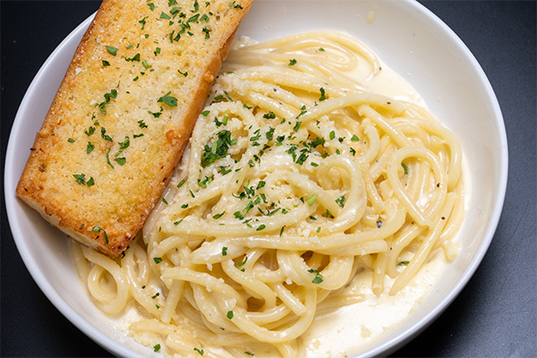Fettuccine Alfredo with Garlic Bread, part of our authentic Italian food near Collingswood, NJ.