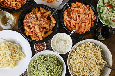 Table covered with multiple pasta dishes, including the Cacio e Pepe near Cherry Hill, New Jersey.